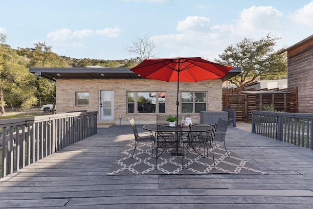7067 Comanche Trl, Austin, TX 78732 - wooden terrace with outdoor dining space