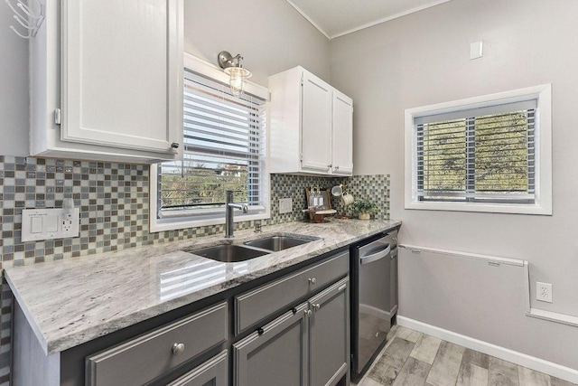 7067 Comanche Trl, Austin, TX 78732 - kitchen featuring a sink, dishwasher, light stone counters, white cabinetry, and light wood-type flooring