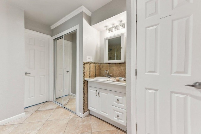 7067 Comanche Trl, Austin, TX 78732 - bathroom with crown molding, vanity, tile patterned flooring, and baseboards