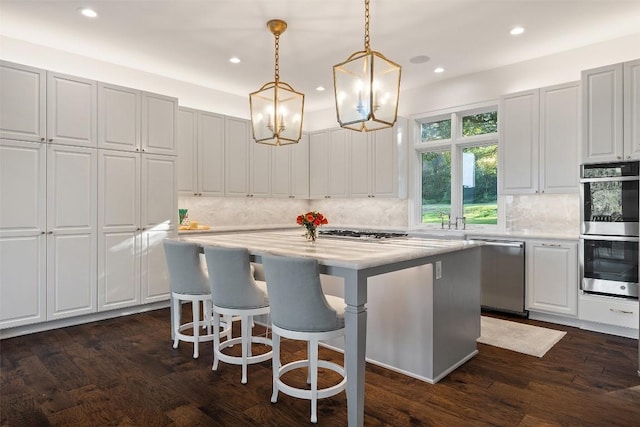 1106 Blackacre Trl, West Lake Hills, TX 78746 - kitchen with dark wood-style flooring, a center island, stainless steel appliances, recessed lighting, and decorative backsplash