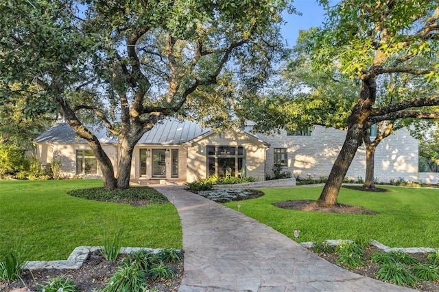 1106 Blackacre Trl, West Lake Hills, TX 78746 - view of front of home with a standing seam roof, metal roof, and a front lawn