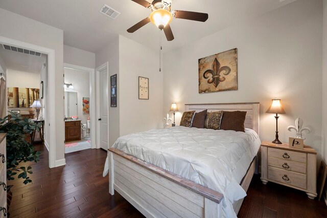 2429 Carretera Dr, Leander, TX 78641 - bedroom with dark wood-type flooring, connected bathroom, baseboards, and a ceiling fan
