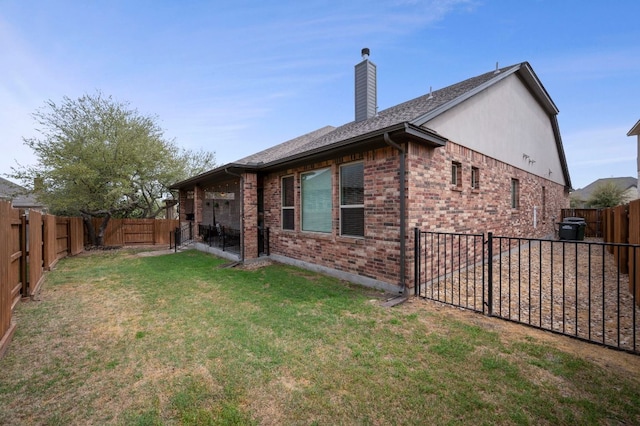 2429 Carretera Dr, Leander, TX 78641 - back of house with brick siding, a chimney, and a shingled roof