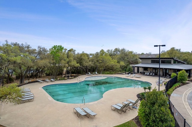 2429 Carretera Dr, Leander, TX 78641 - community pool featuring a patio area and view of wooded area