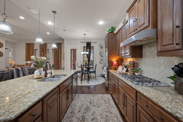 2429 Carretera Dr, Leander, TX 78641 - kitchen featuring a sink, under cabinet range hood, stainless steel appliances, dark wood-style floors, and tasteful backsplash