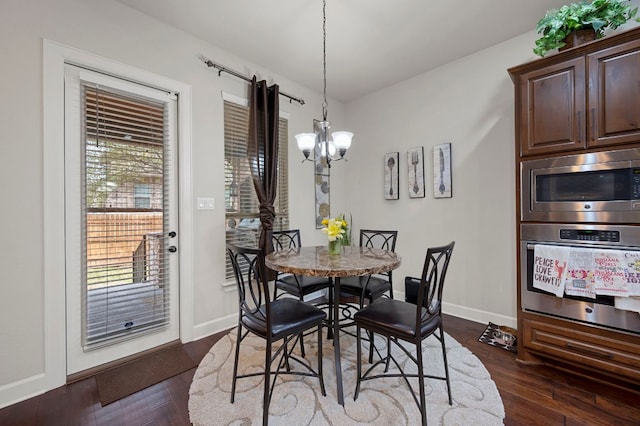 2429 Carretera Dr, Leander, TX 78641 - dining room featuring a chandelier, dark wood-type flooring, and baseboards