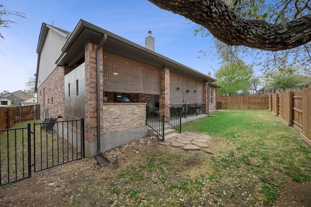 2429 Carretera Dr, Leander, TX 78641 - view of home's exterior featuring brick siding and a chimney