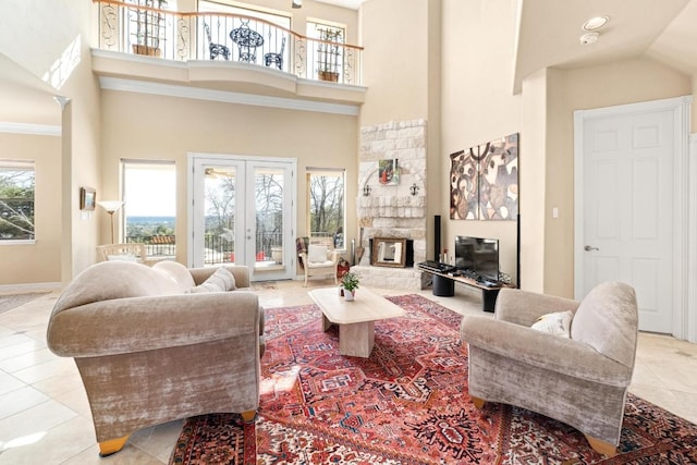 329 Park Place Dr, Georgetown, TX 78628 - living room with a high ceiling, tile patterned floors, baseboards, and a fireplace