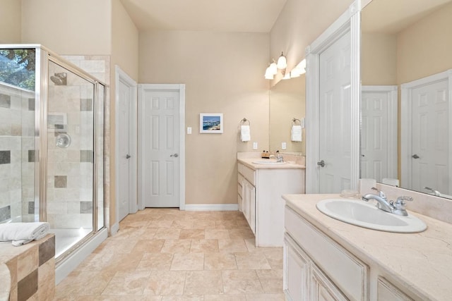 329 Park Place Dr, Georgetown, TX 78628 - bathroom with a shower stall, two vanities, and baseboards