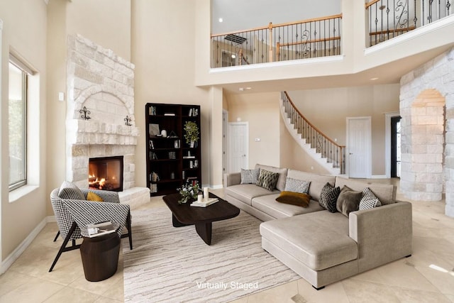 329 Park Place Dr, Georgetown, TX 78628 - tiled living room with a high ceiling, a fireplace, stairway, and baseboards