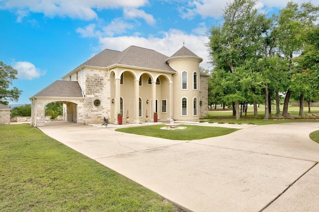 329 Park Place Dr, Georgetown, TX 78628 - french country style house featuring concrete driveway, a front lawn, stone siding, and stucco siding