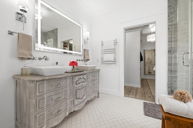 full bath with radiator heating unit, double vanity, a sink, and a stall shower