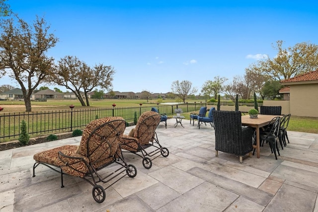 view of patio / terrace with a fenced backyard, outdoor dining space, and a residential view