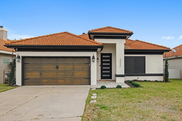 mediterranean / spanish house featuring a tile roof, stucco siding, a garage, and concrete driveway