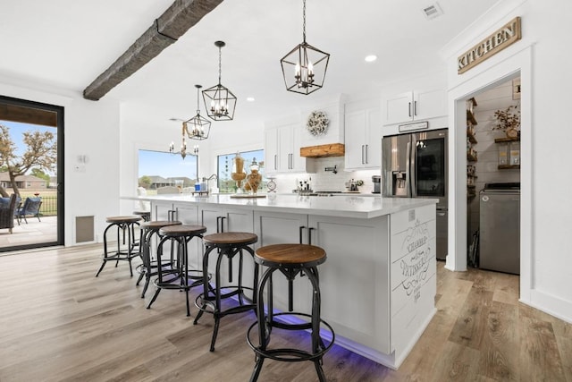 30224 Briarcrest Dr, Georgetown, TX 78628 - kitchen featuring a chandelier, stainless steel fridge, a healthy amount of sunlight, and visible vents