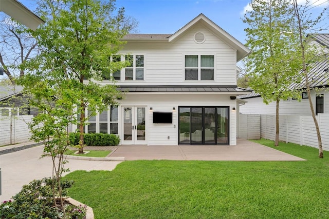 back of property featuring french doors, a fenced backyard, a standing seam roof, and metal roof