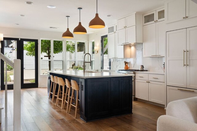 1804 Ann Arbor Ave, Austin, TX 78704 - kitchen featuring a sink, hardwood / wood-style flooring, recessed lighting, a kitchen island with sink, and light countertops