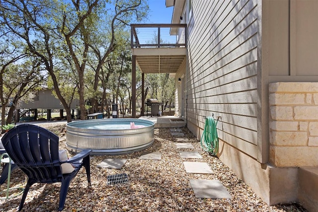 view of yard with a balcony