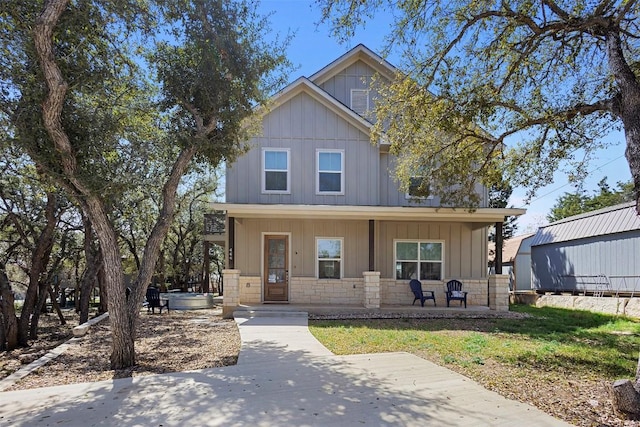 view of front of home featuring stone siding and a porch