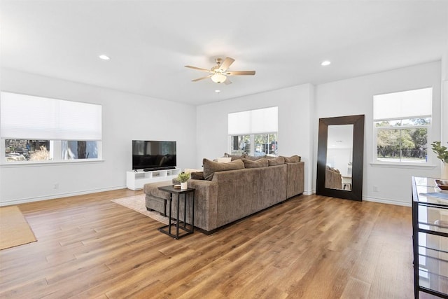 living room with baseboards, light wood-type flooring, recessed lighting, and a ceiling fan