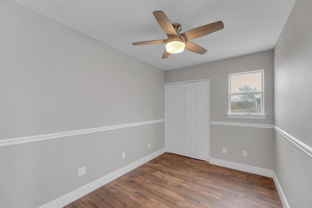20912 High Dr, Lago Vista, TX 78645 - unfurnished bedroom with wood finished floors, baseboards, a closet, and a ceiling fan