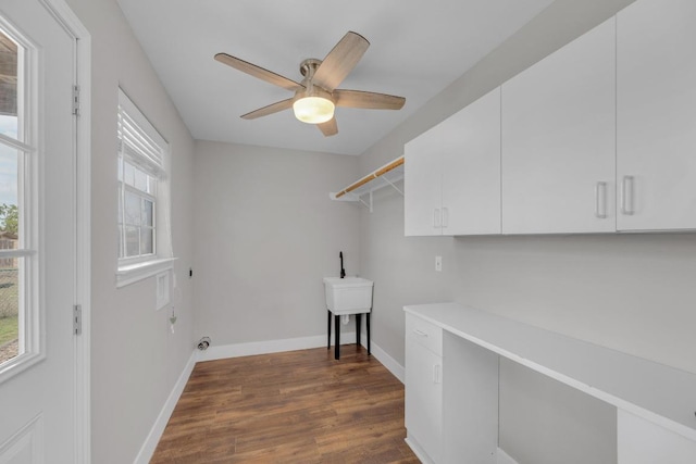 20912 High Dr, Lago Vista, TX 78645 - washroom featuring cabinet space, dark wood-style floors, a ceiling fan, and baseboards