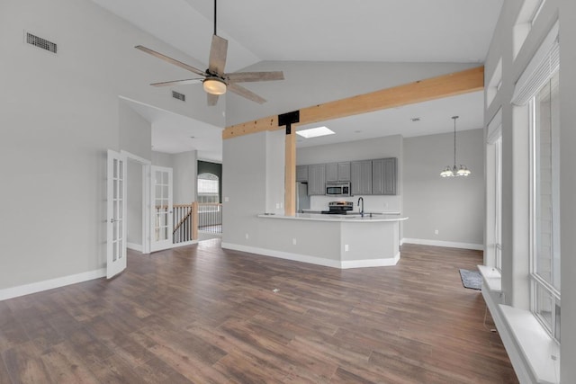 20912 High Dr, Lago Vista, TX 78645 - unfurnished living room with a sink, high vaulted ceiling, dark wood-type flooring, a chandelier, and ceiling fan