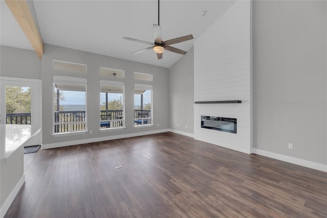 20912 High Dr, Lago Vista, TX 78645 - unfurnished living room featuring healthy amount of natural light, ceiling fan, a large fireplace, wood finished floors, and high vaulted ceiling
