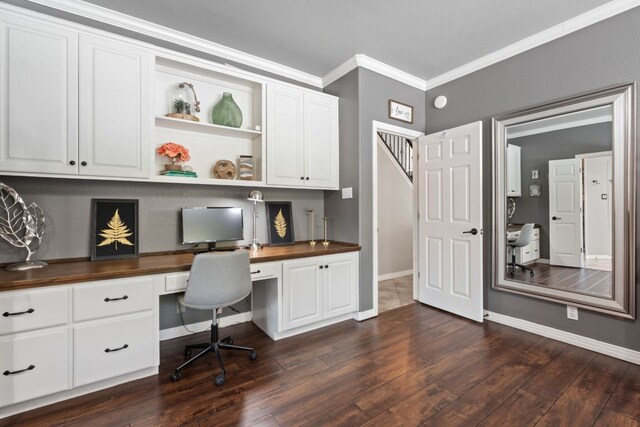 502 Explorer, Lakeway, TX 78734 - home office with built in desk, ornamental molding, and dark wood finished floors