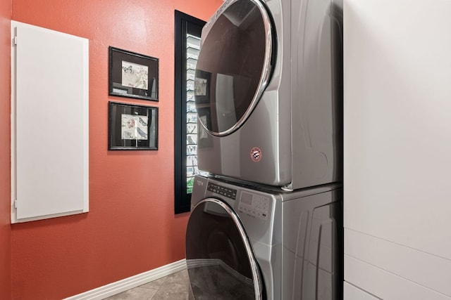 502 Explorer, Lakeway, TX 78734 - washroom featuring stacked washer / dryer, baseboards, and tile patterned flooring