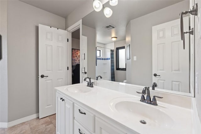 502 Explorer, Lakeway, TX 78734 - bathroom with a shower with shower curtain, double vanity, baseboards, and tile patterned flooring