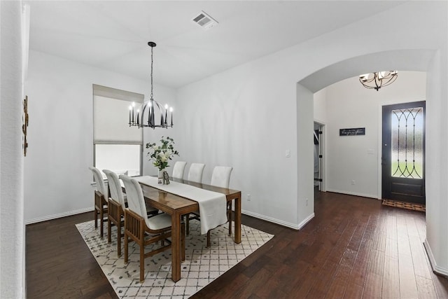 22300 Verbena Pkwy, Spicewood, TX 78669 - dining room featuring a chandelier, arched walkways, and hardwood / wood-style floors