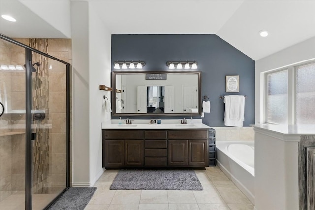 22300 Verbena Pkwy, Spicewood, TX 78669 - full bathroom with a bath, double vanity, a stall shower, lofted ceiling, and tile patterned floors