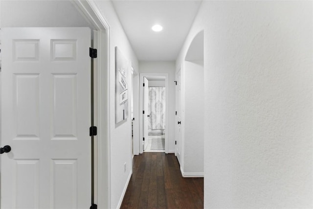 22300 Verbena Pkwy, Spicewood, TX 78669 - hall with dark wood-style flooring, arched walkways, a textured wall, and recessed lighting