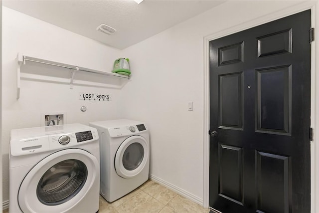 22300 Verbena Pkwy, Spicewood, TX 78669 - washroom with separate washer and dryer and light tile patterned floors