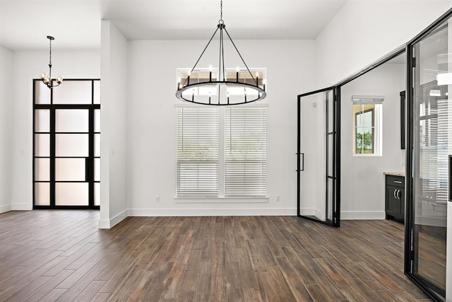 120 NW Strada Luca NW, Florence, TX 76527 - unfurnished dining area with a chandelier and dark wood finished floors