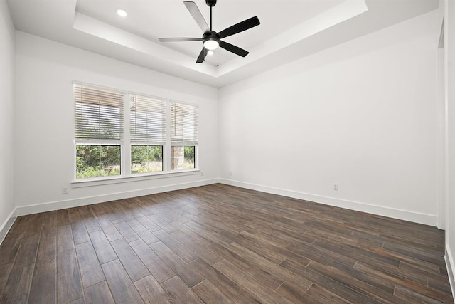 120 NW Strada Luca NW, Florence, TX 76527 - empty room with a tray ceiling, dark wood finished floors, and ceiling fan