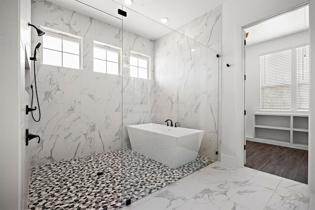 120 NW Strada Luca NW, Florence, TX 76527 - full bath featuring marble look tiles, a freestanding tub, and a marble finish shower