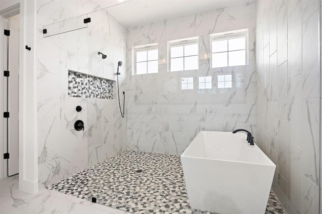 120 NW Strada Luca NW, Florence, TX 76527 - full bathroom with a freestanding tub, a marble finish shower, marble finish floors, and tile walls