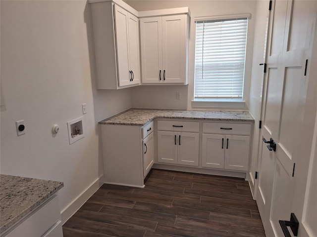120 NW Strada Luca NW, Florence, TX 76527 - laundry area featuring cabinet space, dark wood-style flooring, hookup for an electric dryer, and washer hookup
