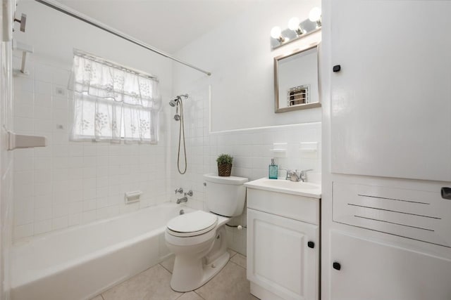 1410 Yorkshire Dr, Austin, TX 78723 - full bathroom featuring tile patterned flooring, shower / tub combination, vanity, tile walls, and a wainscoted wall