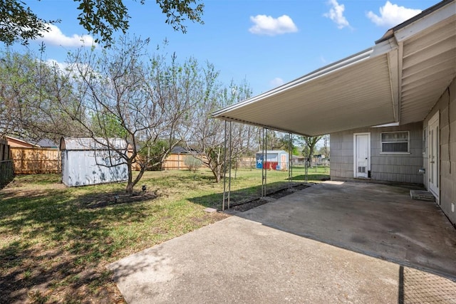 1410 Yorkshire Dr, Austin, TX 78723 - fenced backyard with a storage unit, a carport, and a patio