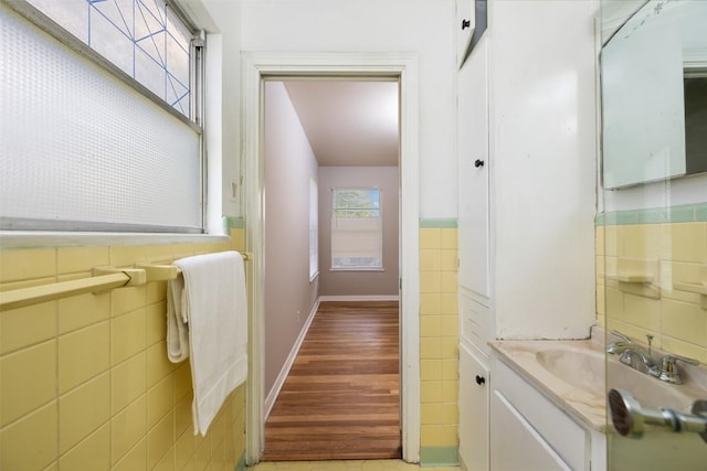 1410 Yorkshire Dr, Austin, TX 78723 - bathroom featuring tile walls, vanity, and a wainscoted wall