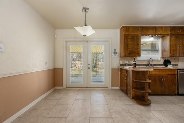 1410 Yorkshire Dr, Austin, TX 78723 - kitchen with french doors, open shelves, stainless steel dishwasher, hanging light fixtures, and light tile patterned flooring