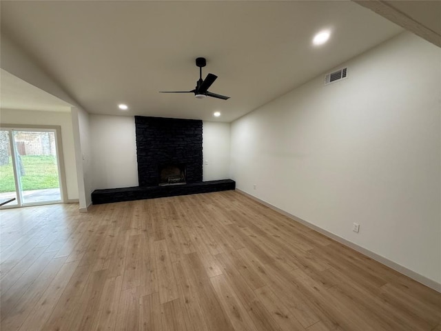 1402 Cardinal Hill Dr, Austin, TX 78758 - unfurnished living room with ceiling fan, wood finished floors, baseboards, recessed lighting, and a large fireplace