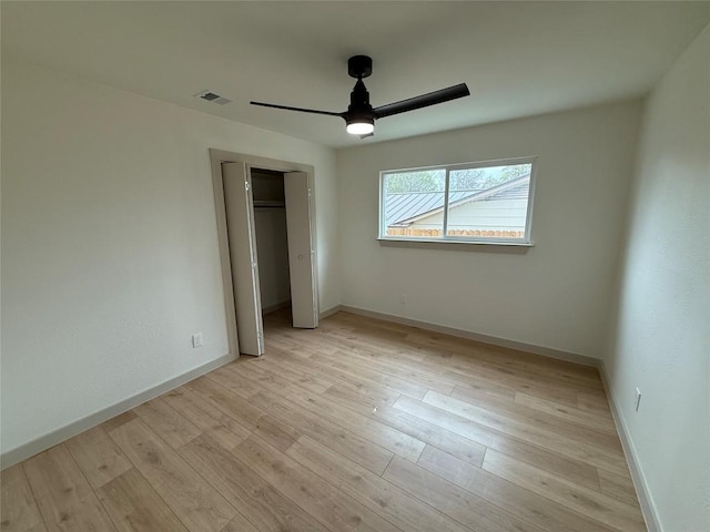 1402 Cardinal Hill Dr, Austin, TX 78758 - unfurnished bedroom featuring a closet, light wood-style floors, a ceiling fan, and baseboards
