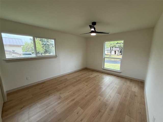 1402 Cardinal Hill Dr, Austin, TX 78758 - unfurnished room with baseboards, a ceiling fan, and light wood-style floors