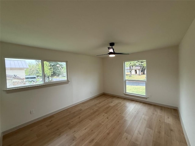 1402 Cardinal Hill Dr, Austin, TX 78758 - unfurnished room with baseboards, a ceiling fan, and light wood-style floors