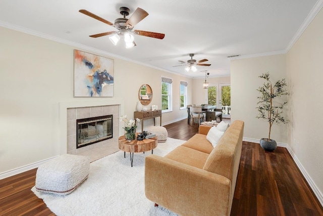 3242 Brass Buttons Trl, Austin, TX 78734 - living room featuring wood finished floors, a ceiling fan, crown molding, baseboards, and a tile fireplace