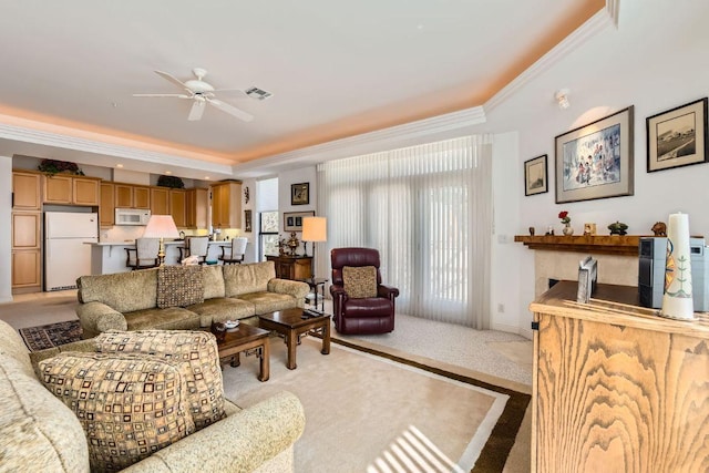 1115 W 7th St W Unit 202, Austin, TX 78703 - living room with ornamental molding, light carpet, a ceiling fan, and a tray ceiling